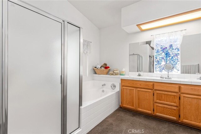 full bathroom with double vanity, a bath, carpet floors, a shower stall, and a sink