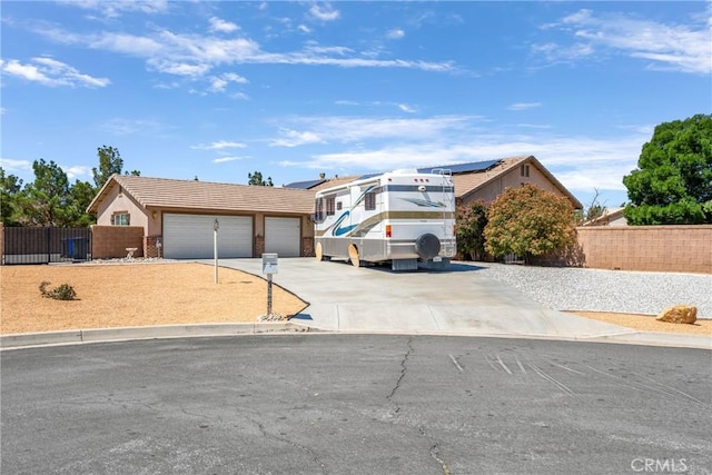 single story home featuring a garage, driveway, fence, and stucco siding