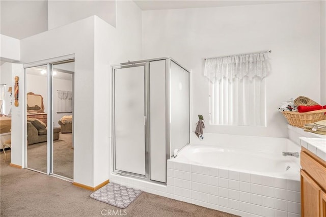 ensuite bathroom with carpet, a garden tub, a stall shower, vanity, and ensuite bath