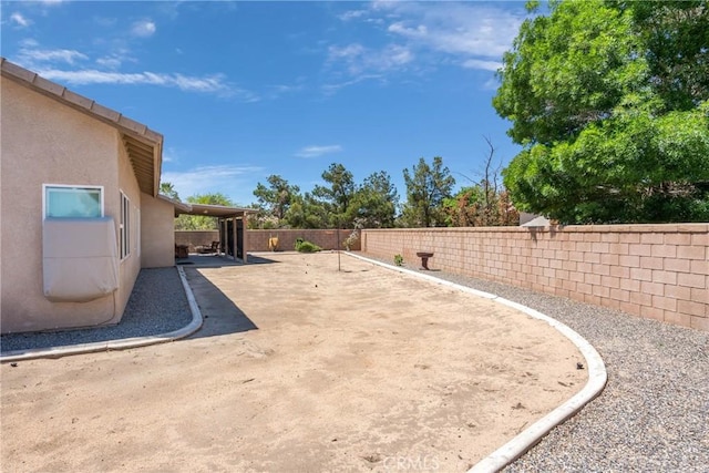 view of yard with a patio area and a fenced backyard