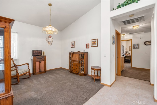 living area featuring light colored carpet and high vaulted ceiling