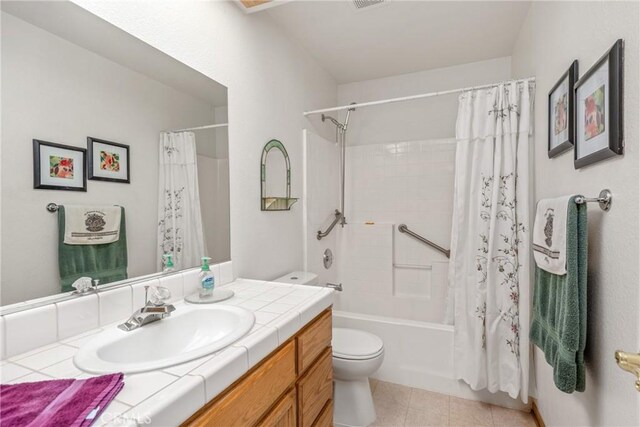 full bathroom with shower / bath combo, tile patterned flooring, vanity, and toilet