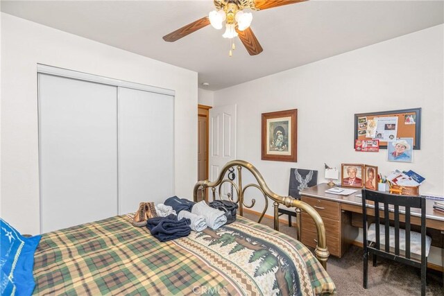 carpeted bedroom with ceiling fan and a closet