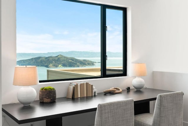 dining area featuring a water and mountain view