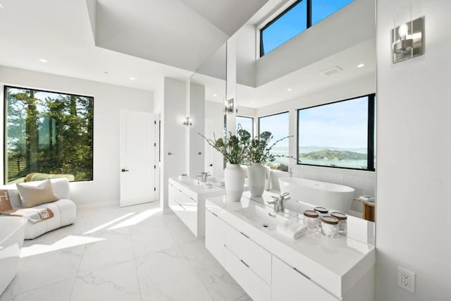 bathroom with vanity and a bath