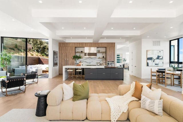 living room featuring light hardwood / wood-style flooring and beamed ceiling