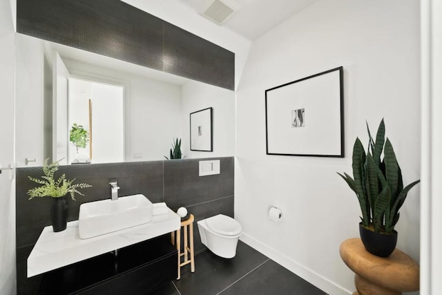 bathroom with vanity, tile patterned floors, and toilet