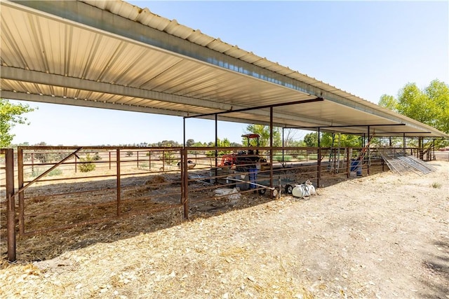 view of horse barn with a rural view