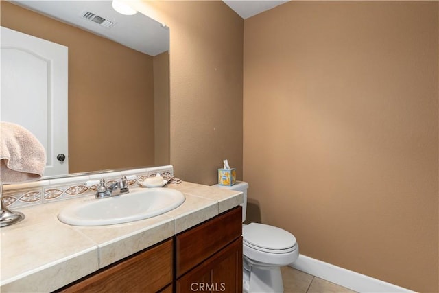 bathroom featuring toilet, vanity, and tile patterned floors