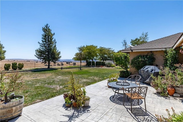 view of patio / terrace featuring a grill and a rural view