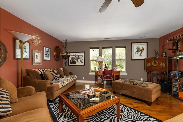 living room featuring hardwood / wood-style flooring and ceiling fan