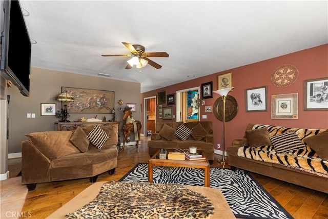 living room featuring hardwood / wood-style flooring and ceiling fan