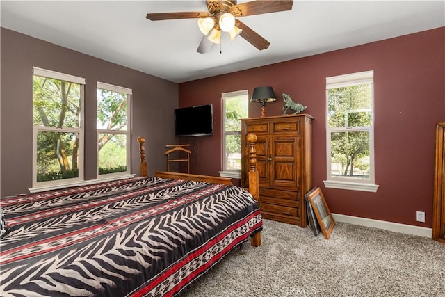 bedroom featuring carpet flooring, multiple windows, and ceiling fan