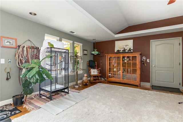 sitting room featuring hardwood / wood-style floors and lofted ceiling