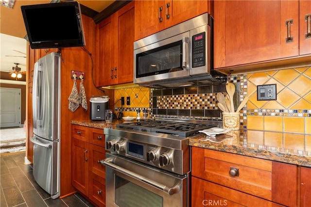 kitchen featuring backsplash, stainless steel appliances, ceiling fan, and stone countertops