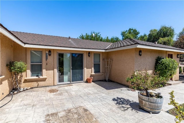 back of property with a patio