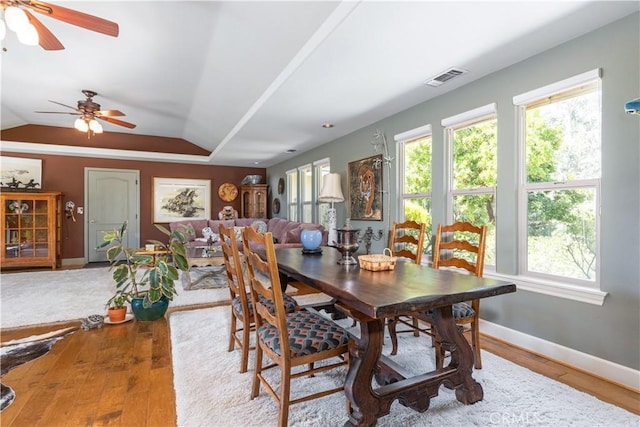 dining room with hardwood / wood-style flooring, ceiling fan, and lofted ceiling