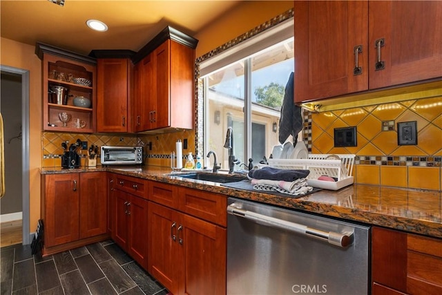 kitchen featuring tasteful backsplash, dark stone countertops, dishwasher, and sink