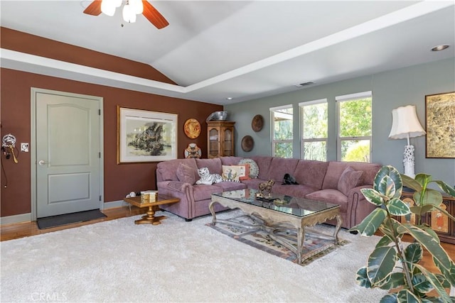 living room with hardwood / wood-style floors, ceiling fan, and lofted ceiling