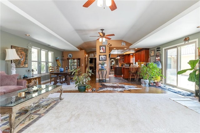 living room featuring ceiling fan and lofted ceiling