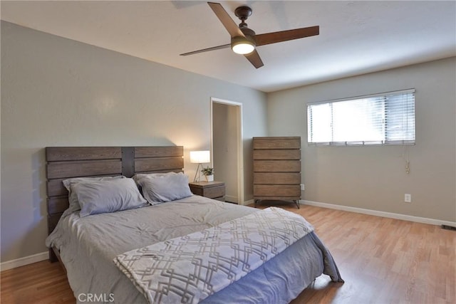 bedroom with light wood-type flooring and ceiling fan