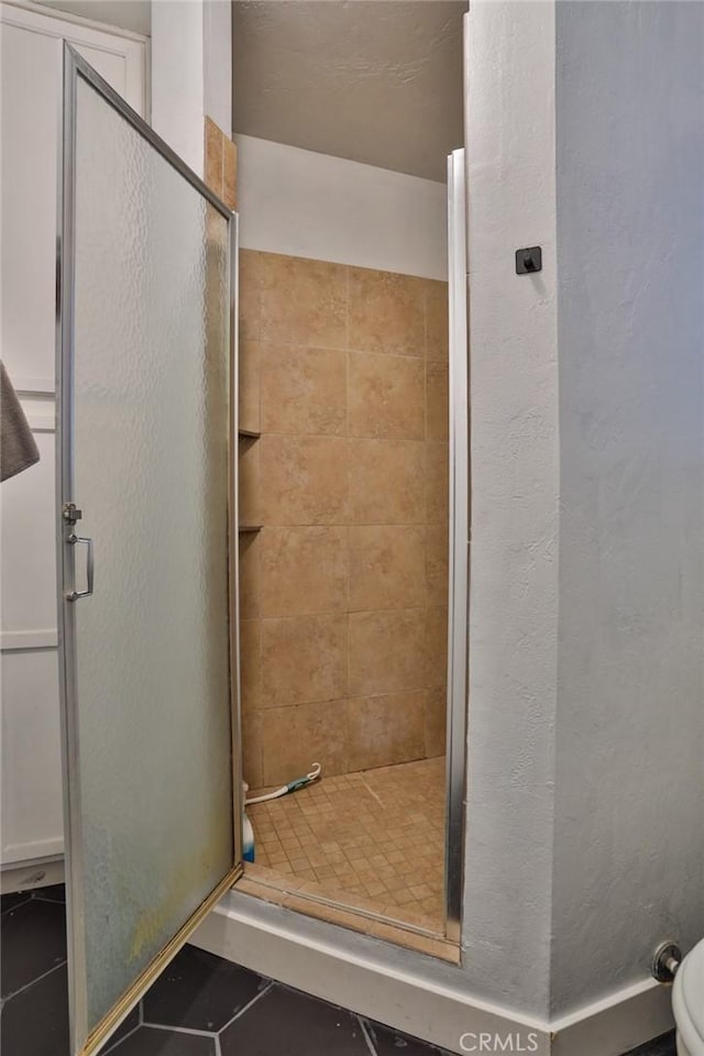 bathroom featuring tile patterned flooring and walk in shower