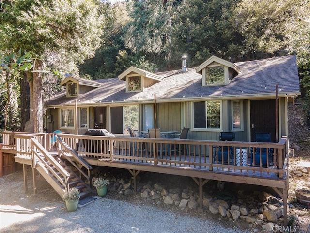 rear view of house featuring a deck