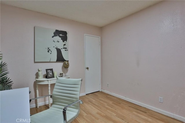 home office with light hardwood / wood-style flooring