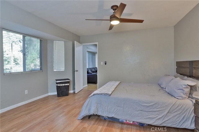 bedroom with hardwood / wood-style floors and ceiling fan