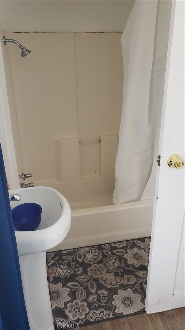 bathroom featuring shower / bathtub combination with curtain and wood-type flooring