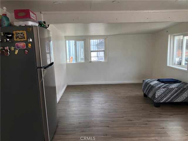 kitchen featuring stainless steel refrigerator and dark hardwood / wood-style flooring