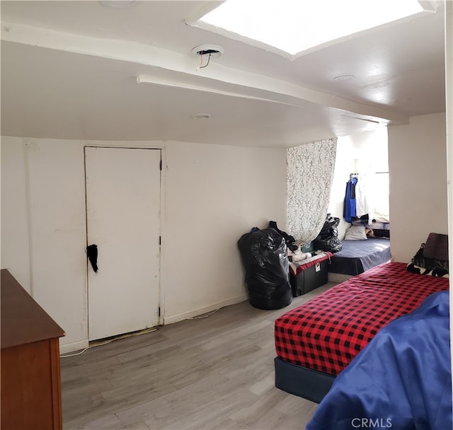 bedroom with vaulted ceiling and light hardwood / wood-style floors