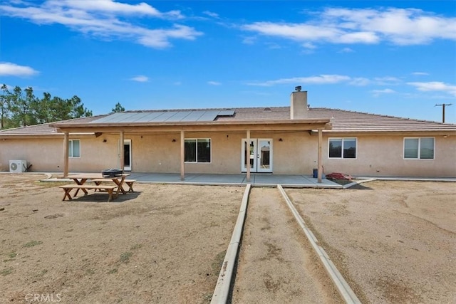 back of property with a patio