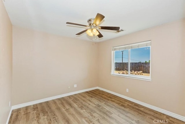 empty room with ceiling fan and wood-type flooring