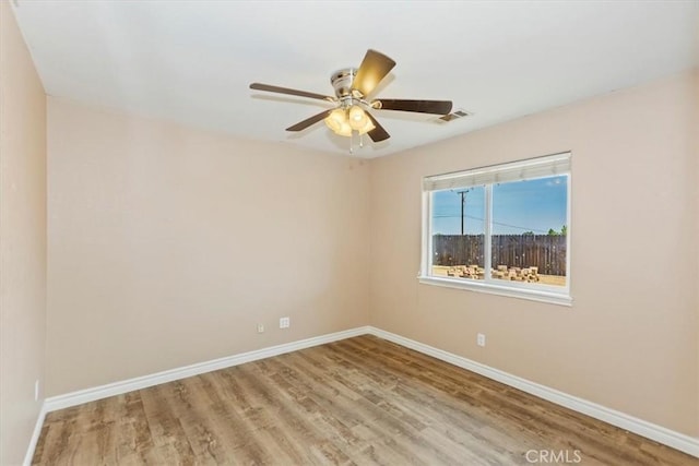 unfurnished room featuring hardwood / wood-style flooring and ceiling fan