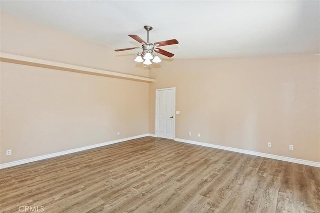 unfurnished room with light hardwood / wood-style floors, ceiling fan, and vaulted ceiling