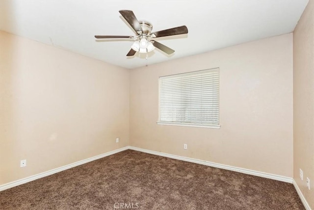 empty room featuring ceiling fan and dark colored carpet