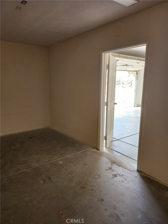 empty room with concrete flooring