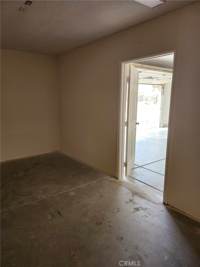 spare room with concrete flooring