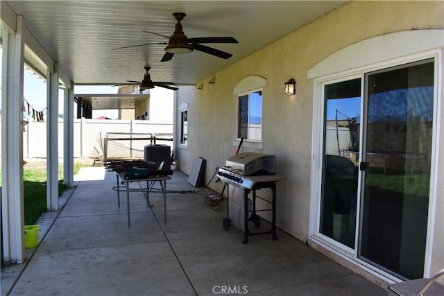 view of patio with area for grilling and ceiling fan