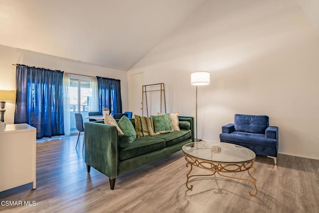 living room with hardwood / wood-style flooring and high vaulted ceiling