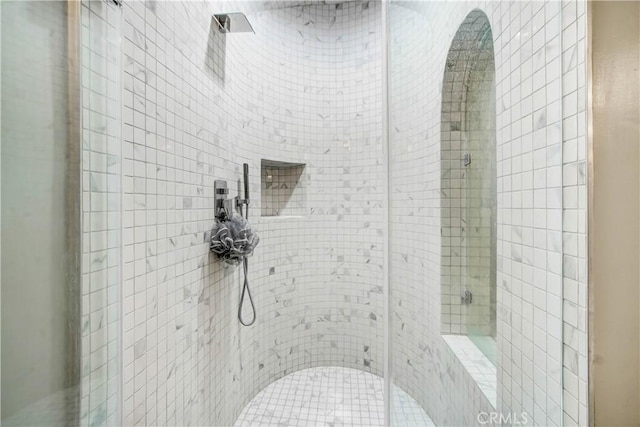 bathroom with a tile shower