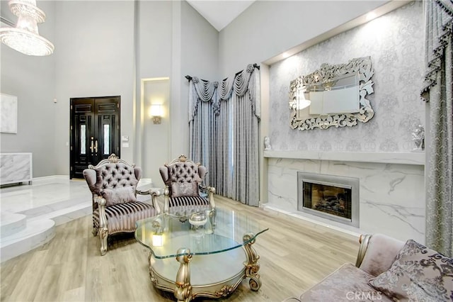 living room with hardwood / wood-style floors and high vaulted ceiling