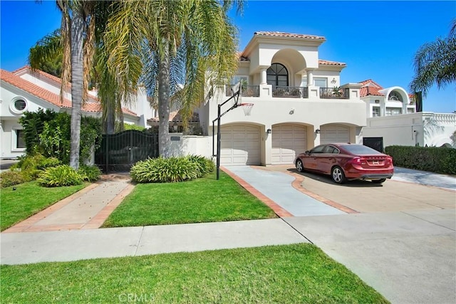 mediterranean / spanish house with a balcony, a front yard, and a garage