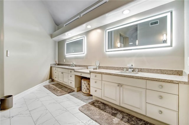 bathroom featuring vanity and lofted ceiling