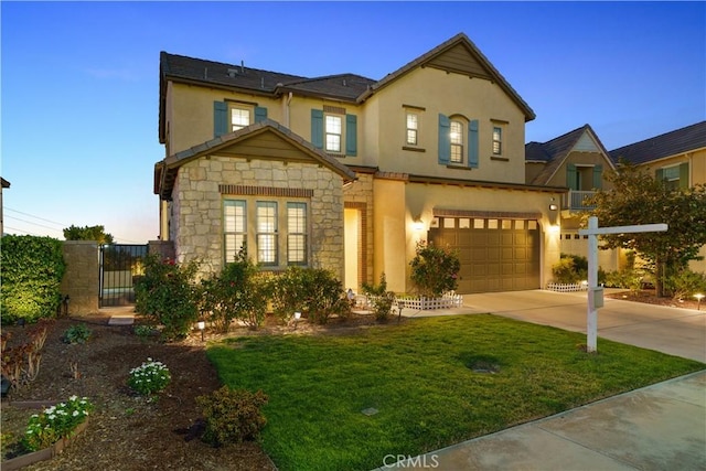 view of front of property with a lawn and a garage