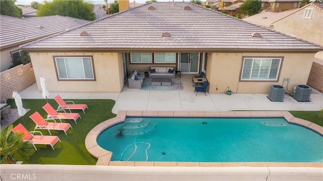 back of house with central air condition unit, outdoor lounge area, and a patio