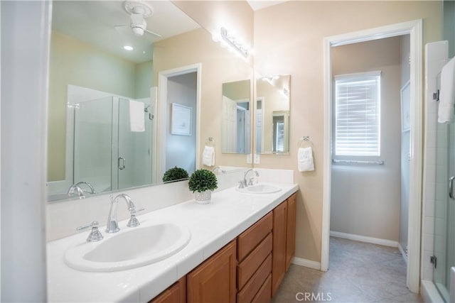 bathroom with tile patterned flooring, vanity, ceiling fan, and a shower with shower door