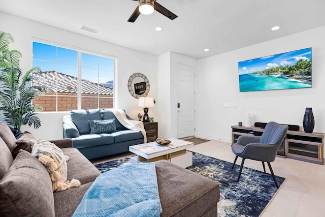 tiled living room with ceiling fan