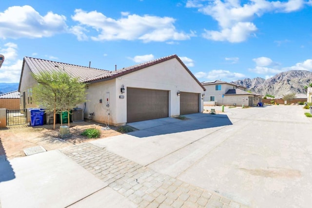 view of front of property with a mountain view and a garage